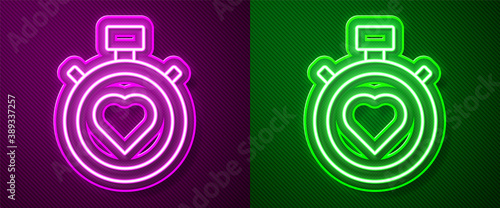 Glowing neon line Heart in the center stopwatch icon isolated on purple and green background. Valentines day. Vector.