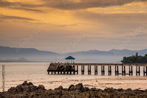 Sunrise or sunset on the sea coast with pier near sea water © sihasakprachum
