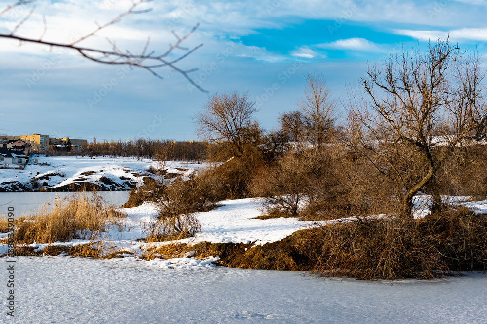 Spacious snow landscape. River and hills in Russia, white winter on the terrain, a lot of fluffy snow and ice under a beautiful blue sky. Rostov region, town of Shakhty, the river Grushevka Spacious snow landscape. River and hills in Russia, white winter on the terrain, a lot of fluffy snow and ice under a beautiful blue sky. Rostov region, town of Shakhty, the river Grushevka