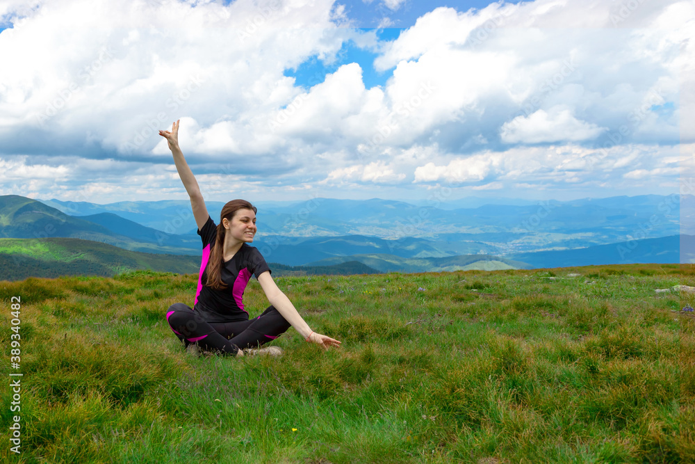Happy woman with raised hands on the background of beautiful mountains. Success. Happy woman with raised hands on the background of beautiful mountains. Success.