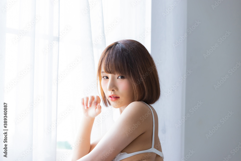 Portrait asian young woman wearing sexy bikini in bedroom Portrait asian young woman wearing sexy bikini in bedroom
