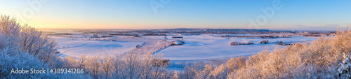 Panorama view at a wintry countryside in sunset