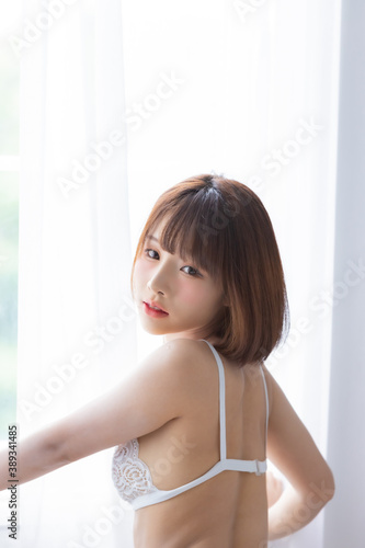 Portrait asian young woman wearing sexy bikini in bedroom