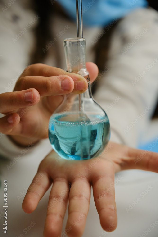 A child playing doctor with glass flask and color liquids. Education and school experiments A child playing doctor with glass flask and color liquids. Education and school experiments