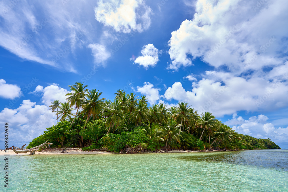 Uninhabited island and lagoon shining in emerald green	
