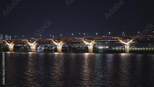 Cheongdam Bridge At Night - Vehicles Passing By On The Illuminated Bridge Across Han River In Seoul - wide shot photo