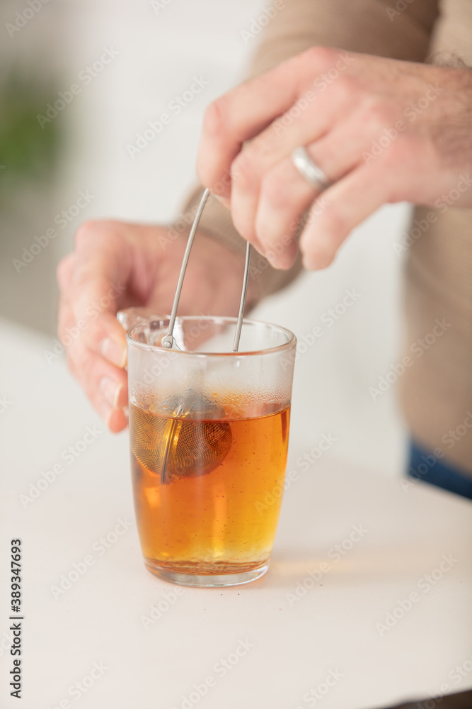 human hands making tea - closeup human hands making tea - closeup