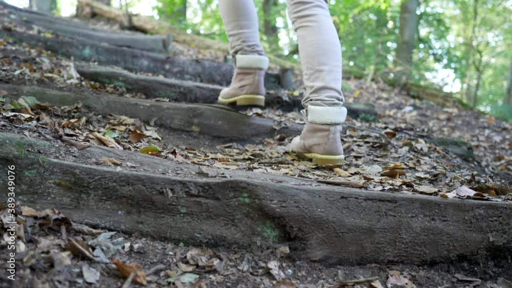 Woman climbs wooden steps in the forest. Slow motion 4K Woman climbs wooden steps in the forest. Slow motion 4K