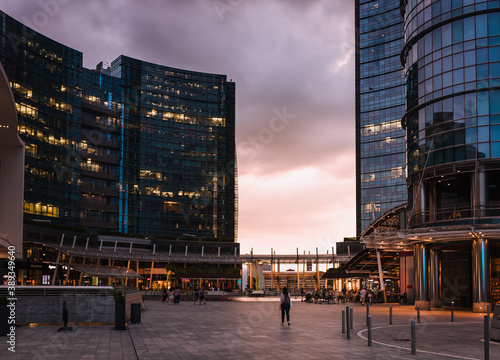 People walking during sunset in Gae Aulenti square, in the new Porta Nuova district in Milan photo