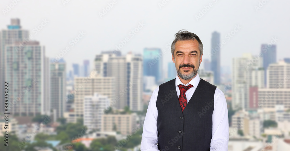 Senior Caucasian businessman with formal wear standing with cityscape in urban panorama view with copy space Senior Caucasian businessman with formal wear standing with cityscape in urban panorama view with copy space