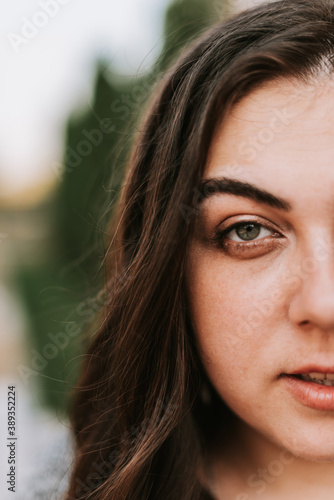 Portrait of a young adult girl on the background of a modern building