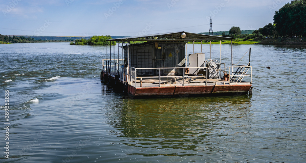 Obraz premium old house barge that floats on the nistru river, Moldova