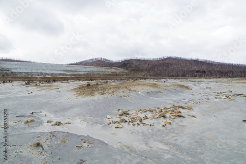 bad ecology, yellow river of chemical elements near the plant. dry yellow land without grass