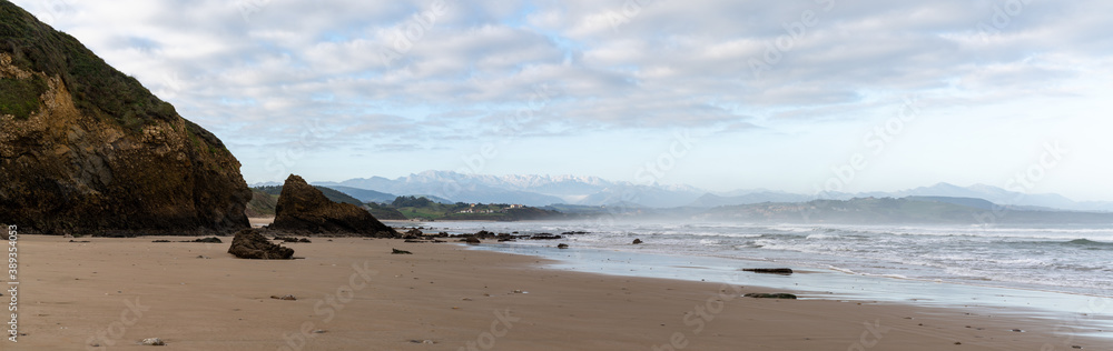 panorama view of wild and rocky and sandy beach at low tide