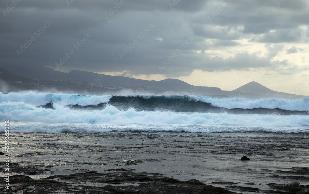 North east  coast of Gran Canaria, powerful ocean waves broought in by distant Epsilon hurricane breaking by the shore next to El Confital beach
