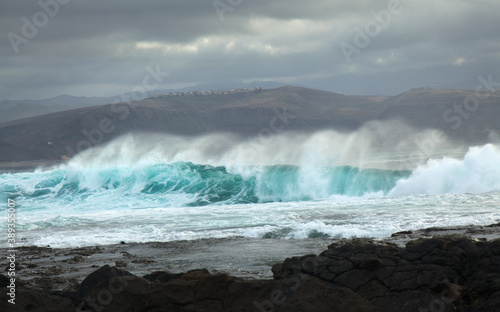 Fototapeta Naklejka Na Ścianę i Meble -  North east  coast of Gran Canaria, powerful ocean waves broought in by distant Epsilon hurricane breaking by the shore next to El Confital beach
