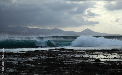 North east  coast of Gran Canaria  powerful ocean waves broought in by distant Epsilon hurricane breaking by the shore next to El Confital beach 