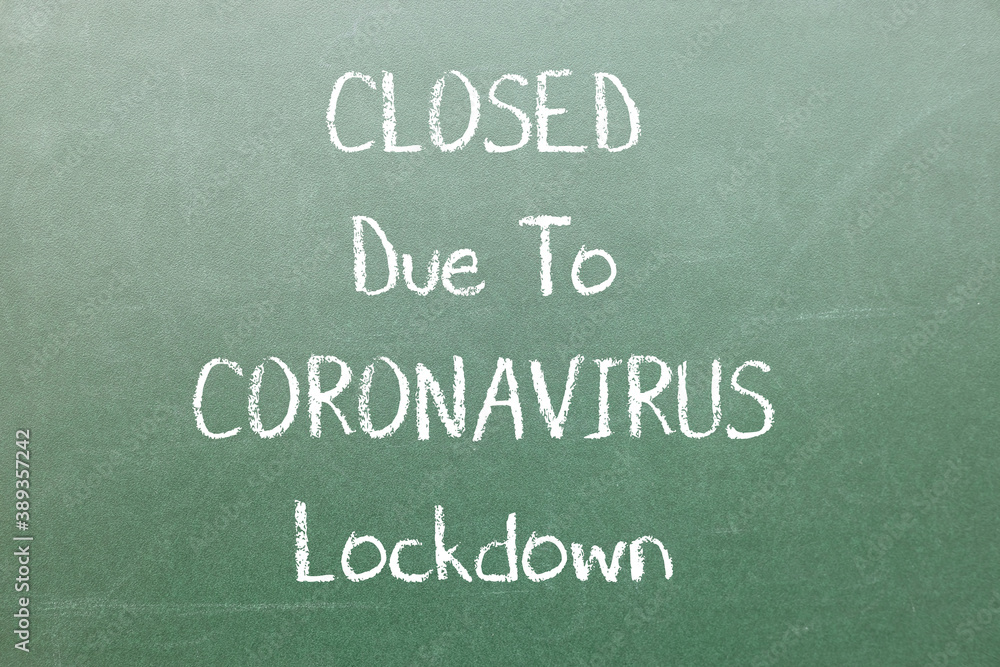 Obraz premium Closed Due To Coronavirus Lockdown Inscription on dark board with chalk. Impact of coronavirus on business.