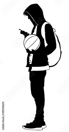 Silhouette of a young man with a ball and a cell phone
