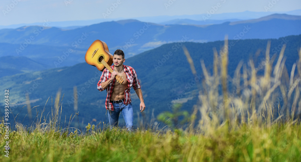 Peaceful hiker. Carefree wanderer. Vast expanses. Conquer the peaks. Man hiker with guitar walking on top of mountain. Guy hiker enjoy pure nature. Musician hiker find inspiration in mountains