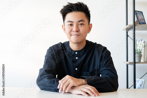 Successful man lifestyle. Professional career. Growth self-development. Portrait of confident smart asian guy looking at camera at light home office with white empty space background.