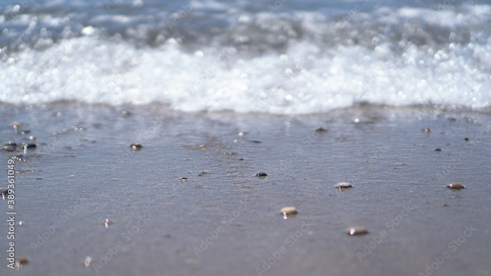 Sea coast and selective focus of wet stones. Small blurred sea wave. Mockup and background. Peace and calm Sea coast and selective focus of wet stones. Small blurred sea wave. Mockup and background. Peace and calm