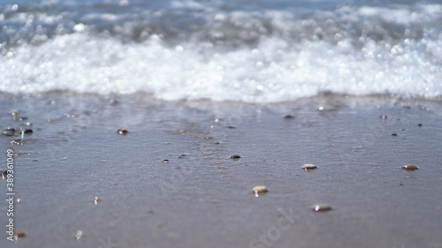 Sea coast and selective focus of wet stones. Small blurred sea wave. Mockup and background. Peace and calm