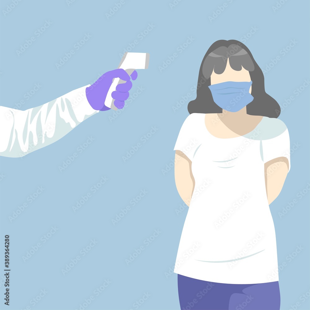 A woman gets her temperature checked during a coronavirus outbreak. Doctor holding a non-contact thermometer in hand. Girl standing with hands behind her back. She's wearing a blue medical mask.