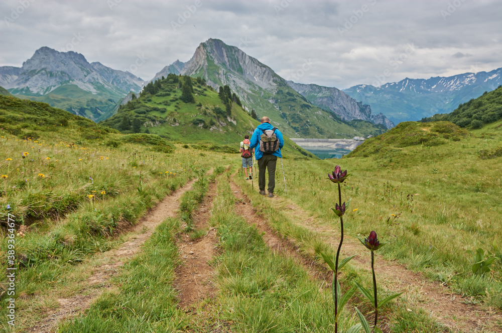 Fototapeta premium Hiking through the mountains in Vorarlberg, Austria. Hiking along the Lechweg in Austria. Hiking through a lonely mountain landscape in Austria. Hiking towards a mountain lake in Austria.
