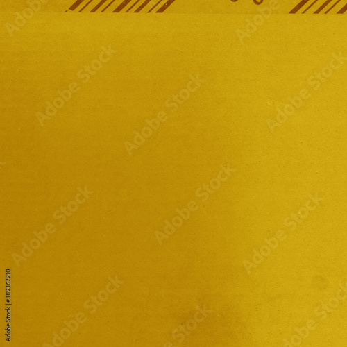 A yellow vintage rough sheet of carton. Recycled environmentally friendly cardboard paper texture. Simple and bright minimalist papercraft background.