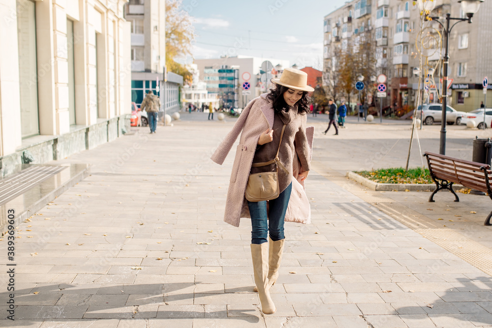 beautiful caucasian brunette woman in a stylish outfit walking down the street in the offseason in a coat and hat
beautiful caucasian brunette woman in a stylish outfit walking down the street in the offseason in a coat and hat
