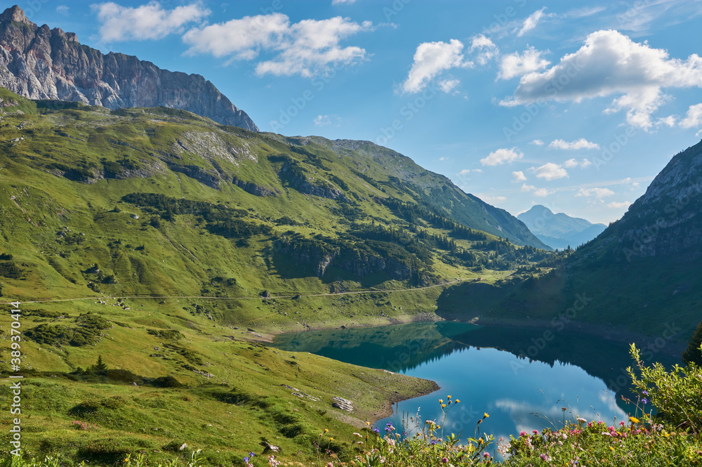 Beautiful mountain lake in Austria. Panoramic view on the Formarinsee in Vorarlberg, Austria. Panoramic mountain landscape in Vorarlberg, austria. Reflecting mountain lake in Austria.