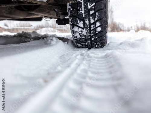 Car wheel in the snow. © schankz