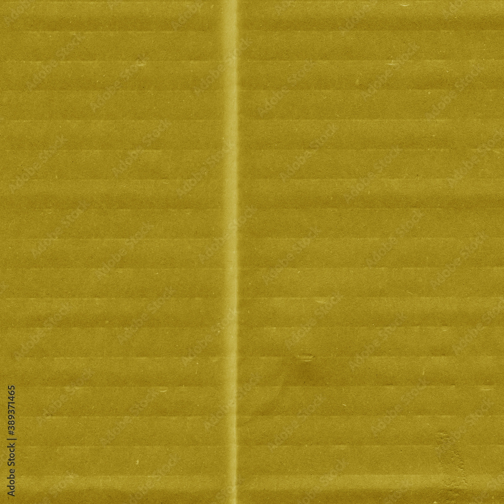 Obraz premium A yellow vintage rough sheet of carton. Recycled environmentally friendly cardboard paper texture. Simple and bright minimalist papercraft background.