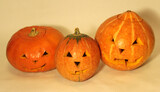 Pumpkins with carved faces on a white background