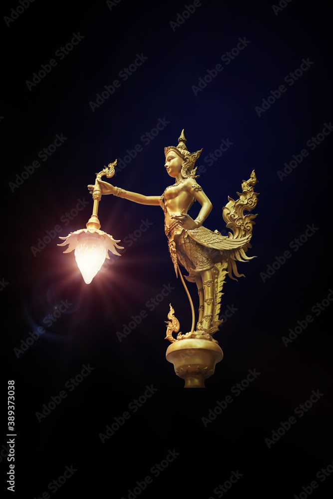 Lamp golden Kinnaree statues isolated on black background Lamp golden Kinnaree statues isolated on black background