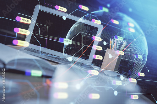 Double exposure of desktop with computer and world map hologram. International data network concept.