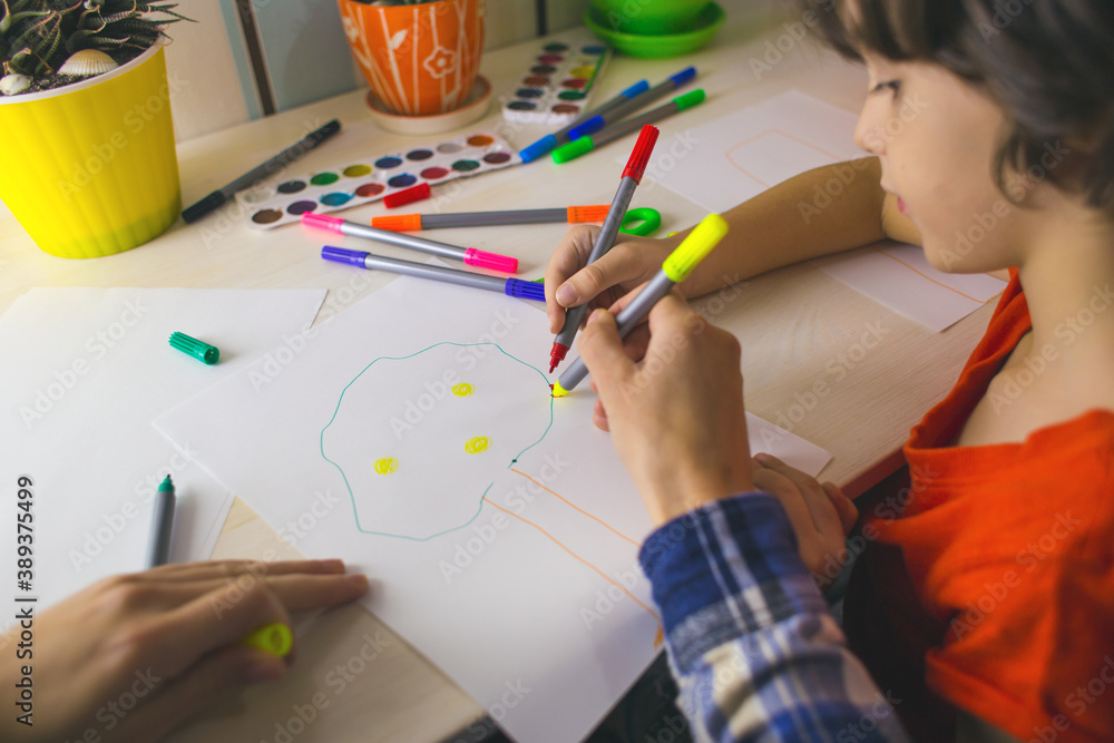 child with a teacher is engaged in art therapy child with a teacher is engaged in art therapy