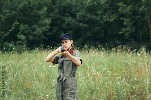 Woman soldier Woman with weapon in hand hunting nature lifestyle black cap 