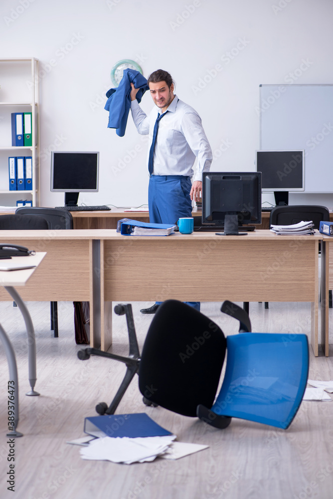 Young male employee unhappy with excessive work Young male employee unhappy with excessive work
