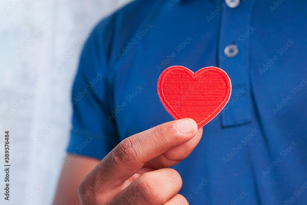  man hand with heart on white background. closeup.