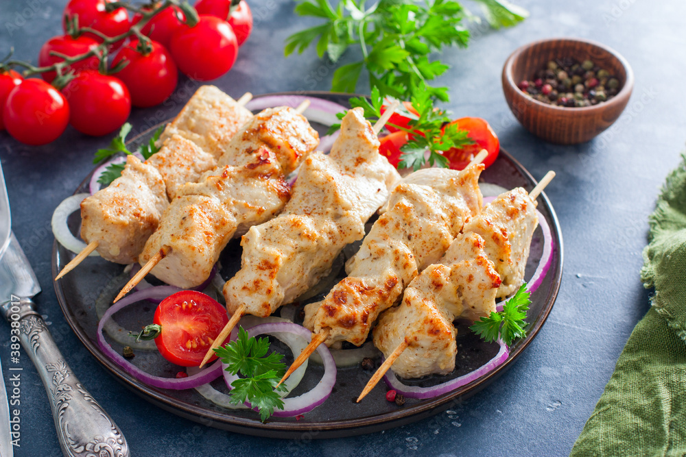 Chicken breast kebab baked in the oven on wooden skewers on a plate, horizontal Chicken breast kebab baked in the oven on wooden skewers on a plate, horizontal
