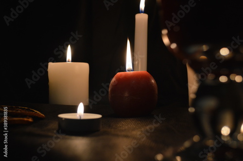 Group of burning candles and mulled wine