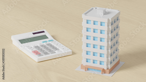 Calculator with a toy apartment placed on a plane.
