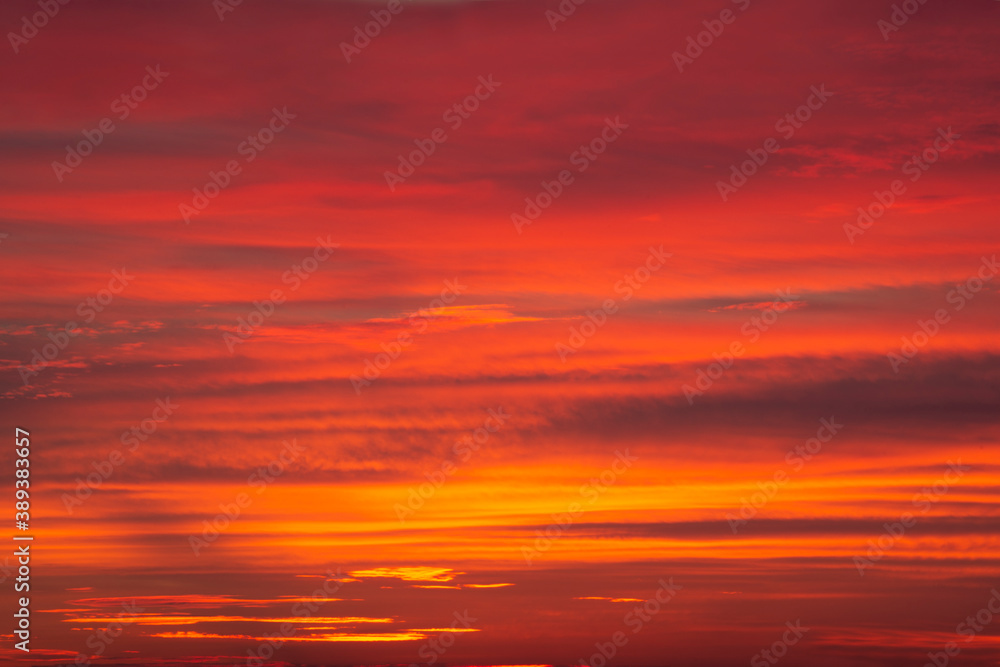 Dramatic red-orange blurred background of the setting sun. Abstract natural multicolor background