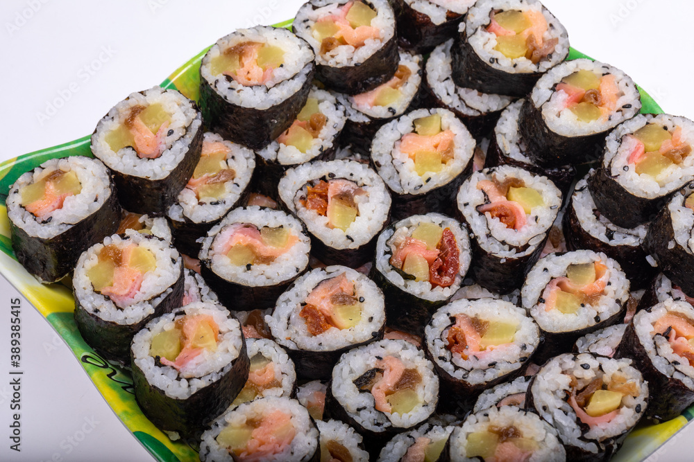 Top view of stack of Japanese sushi maki roll plate. Served in Japanese bar restaurant with chopstick Top view of stack of Japanese sushi maki roll plate. Served in Japanese bar restaurant with chopstick