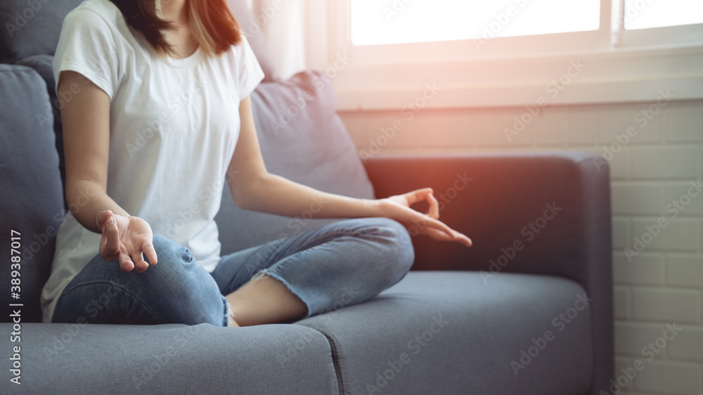 Woman sitting and doing yoga pose To relax