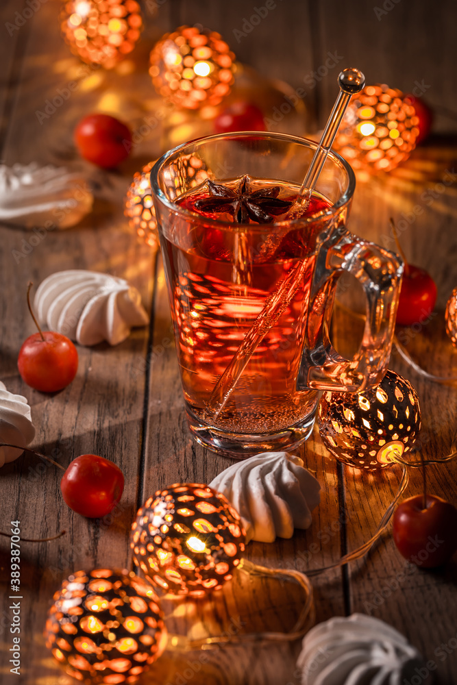 Spicy winter tea or punch with anise and meringue pastry