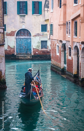 Gondola on a foggy day sailing on narrow canals - Venice, Italy © VladAndrei