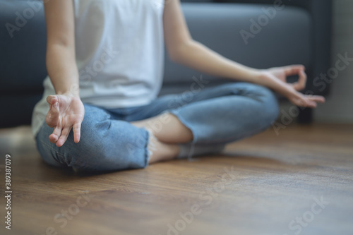 Woman sitting and doing yoga pose To relax